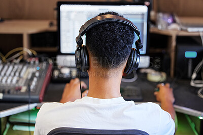 Buy stock photo DJ, computer and man in recording studio for music producer with tech and headphones. Sound engineer, audio technician or back of media editor in professional radio booth with synthesizer control