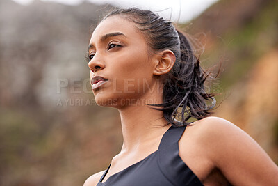 Buy stock photo Shot of a fit young woman catching her breathe while completing her jog outdoors