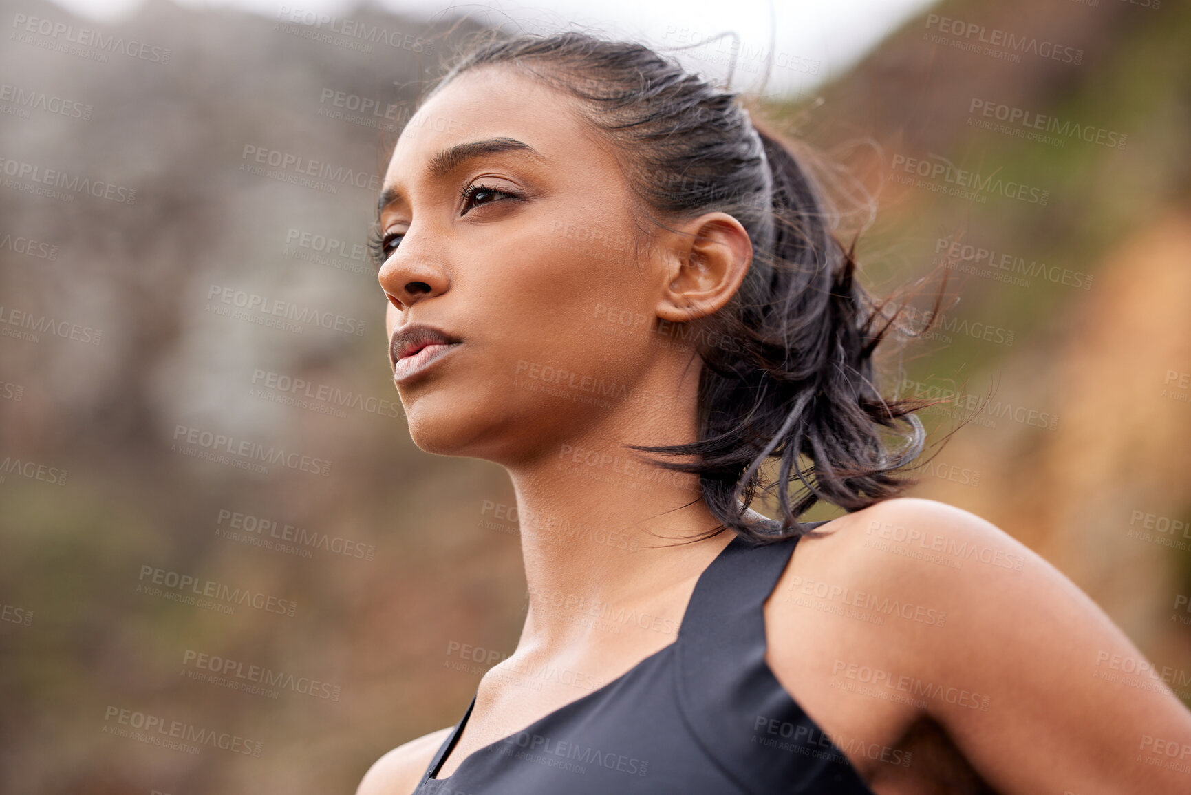 Buy stock photo Shot of a fit young woman catching her breathe while completing her jog outdoors