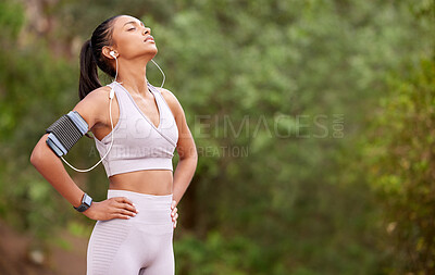 Buy stock photo Running break, tired and woman with music in nature for fitness, exercise and a workout. Sports, rest and young athlete with audio or a playlist while training with cardio in a park with mockup space