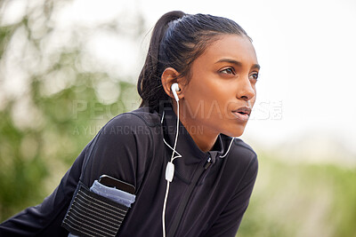 Buy stock photo Shot of a fit young woman catching her breathe while completing her jog outdoors