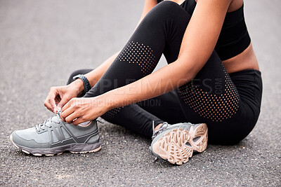 Buy stock photo Fitness, woman tying shoes and sitting road for safety during outdoor marathon training. Running, cardio health and wellness, female athlete fixing laces on footwear and feet of runner on asphalt.