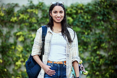 Buy stock photo Portrait, college and woman on campus with skateboard for education, learning and knowledge. Student, skater and person with backpack for happiness, scholarship or confidence on school ground