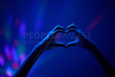 Buy stock photo Lights, heart hands of fan at party or concert at night, stadium lighting and bokeh with mock up. Music festival, love hand sign in silhouette and live performance show with neon light in arena space