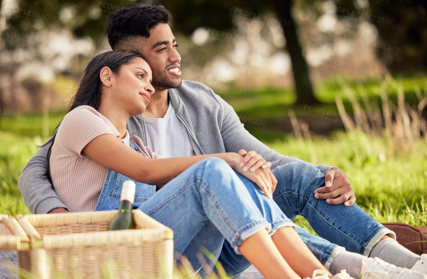 Buy stock photo Couple, picnic and basket on grass for love with celebrate anniversary, alcohol and together with relax. Woman, man and happiness in nature with smile, wine bottle and weekend date for relationship