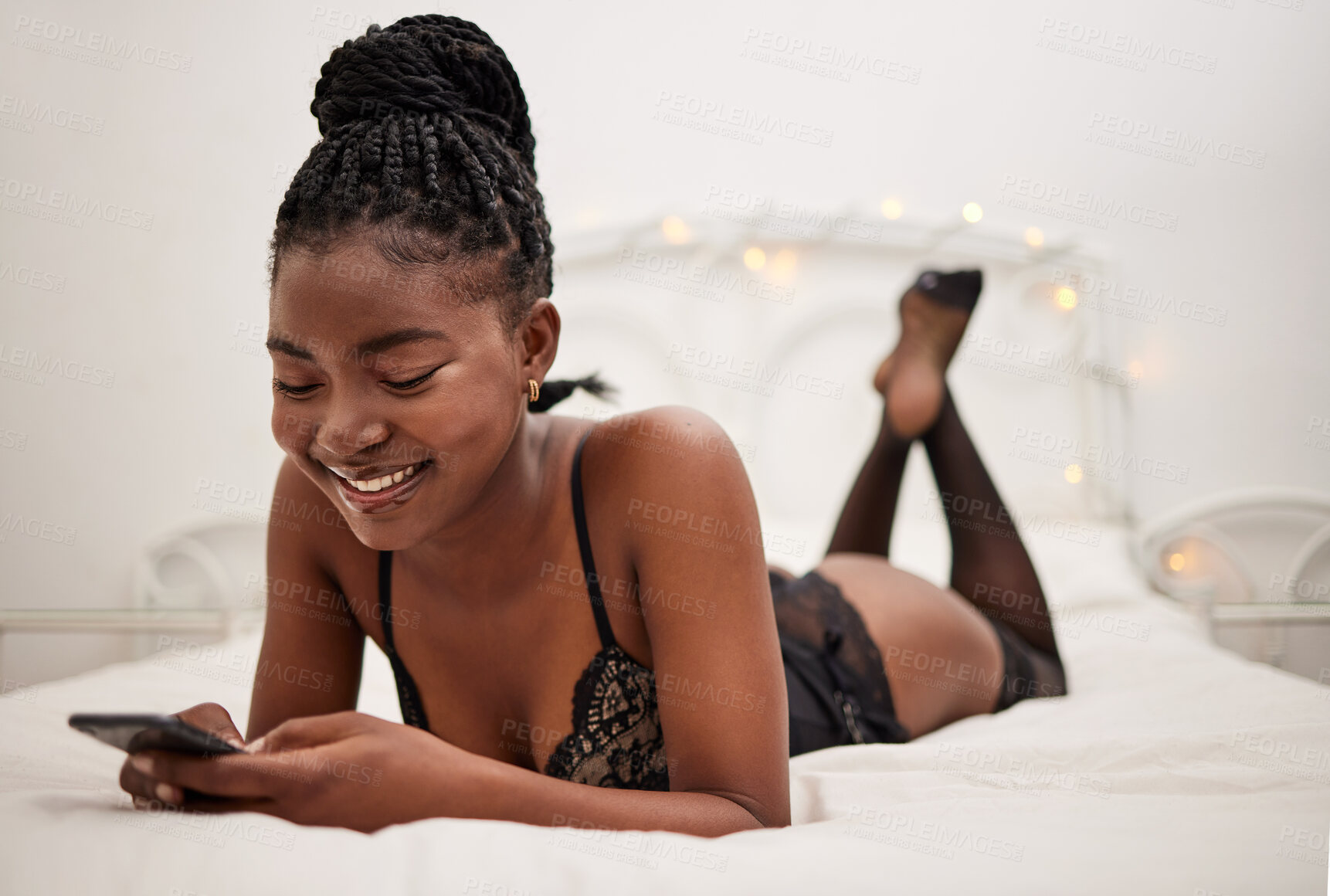 Buy stock photo Lingerie, woman and smartphone in bed for texting, messaging and social media with smile at chat. Sexy, black person and mobile communication in underwear for sexting, romance and flirting online