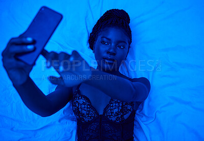 Buy stock photo Sexy selfie, bed and black woman with lighting for a photo for social media or online chat. Above, blue room and an African person taking pictures on a mobile in lingerie for web, an app or sexting