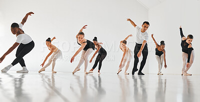 Buy stock photo Shot of a group of young ballet dancers practicing their routine in a dance studio