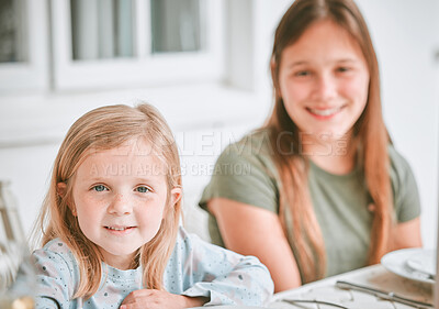 Buy stock photo Shot of two sisters sitting at a lunch table outside
