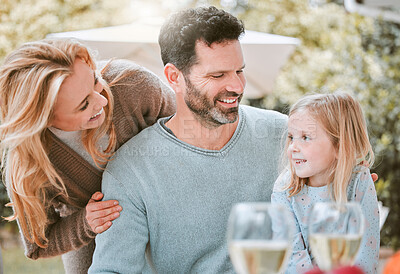 Buy stock photo Shot of a little girl and her parents sitting outside