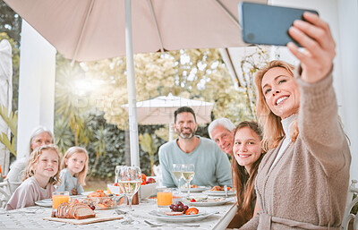 Buy stock photo Shot of a family taking a selfie while having lunch at home
