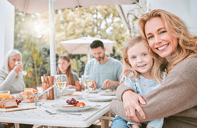 Buy stock photo Shot of a mother hugging her daughter at a family lunch at home