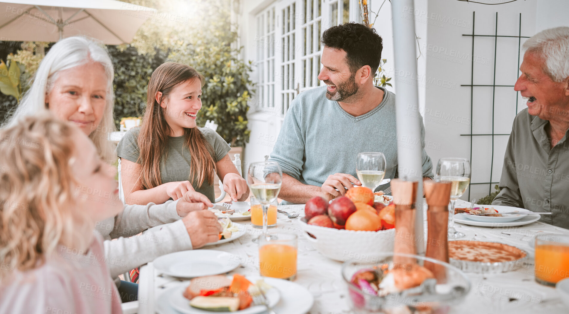 Buy stock photo Shot of a family having lunch outside
