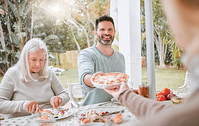 Buy stock photo Shot f a family having lunch outside