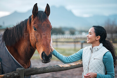 Buy stock photo Shot of an attractive woman posing with a horse in an enclosed pasture on a farm