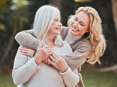 Buy stock photo Shot of a woman standing outside with her elderly mother