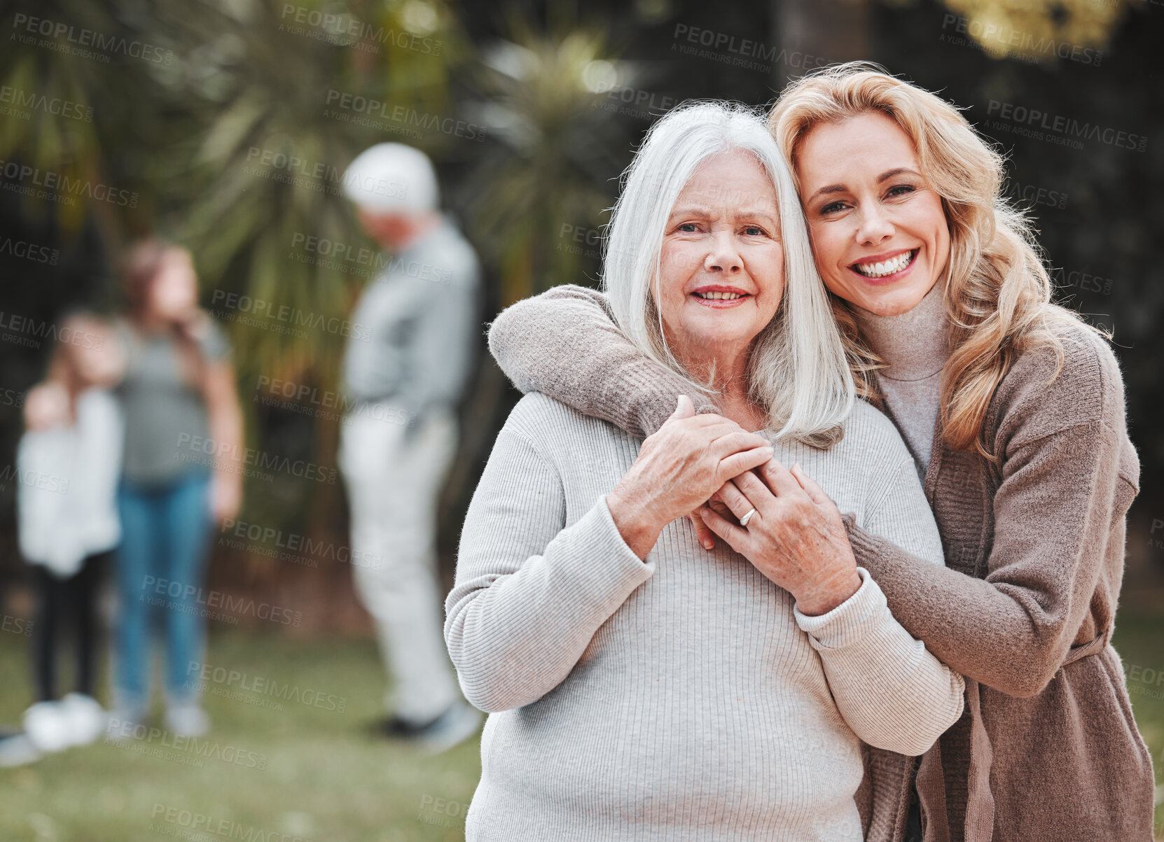 Buy stock photo Shot of a woman standing outside with her elderly mother