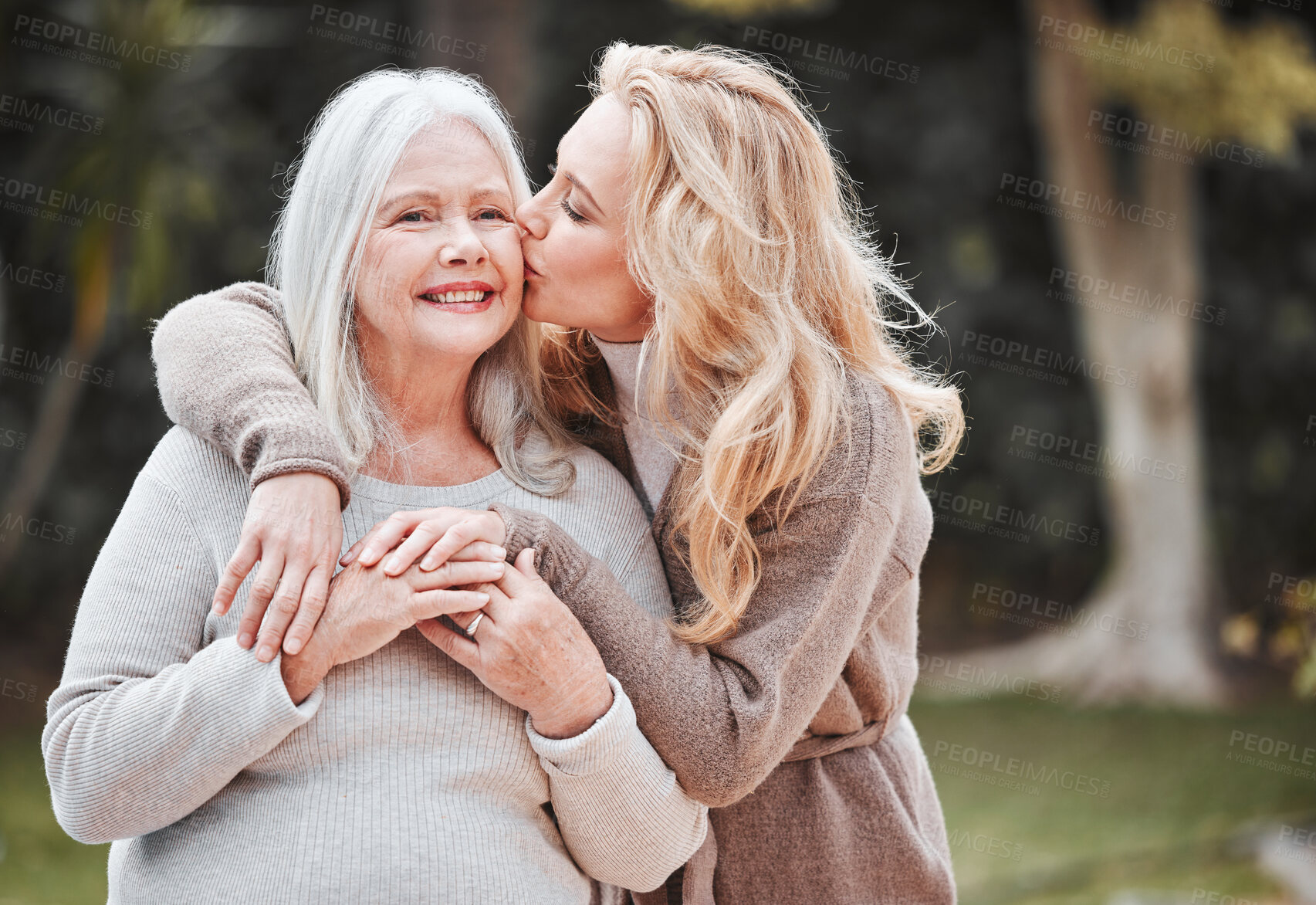 Buy stock photo Kiss, woman and senior mom in garden with smile, gratitude and embrace in outdoor bonding together. Happy family, generation and face of elderly mother with daughter in backyard for hug, care or love