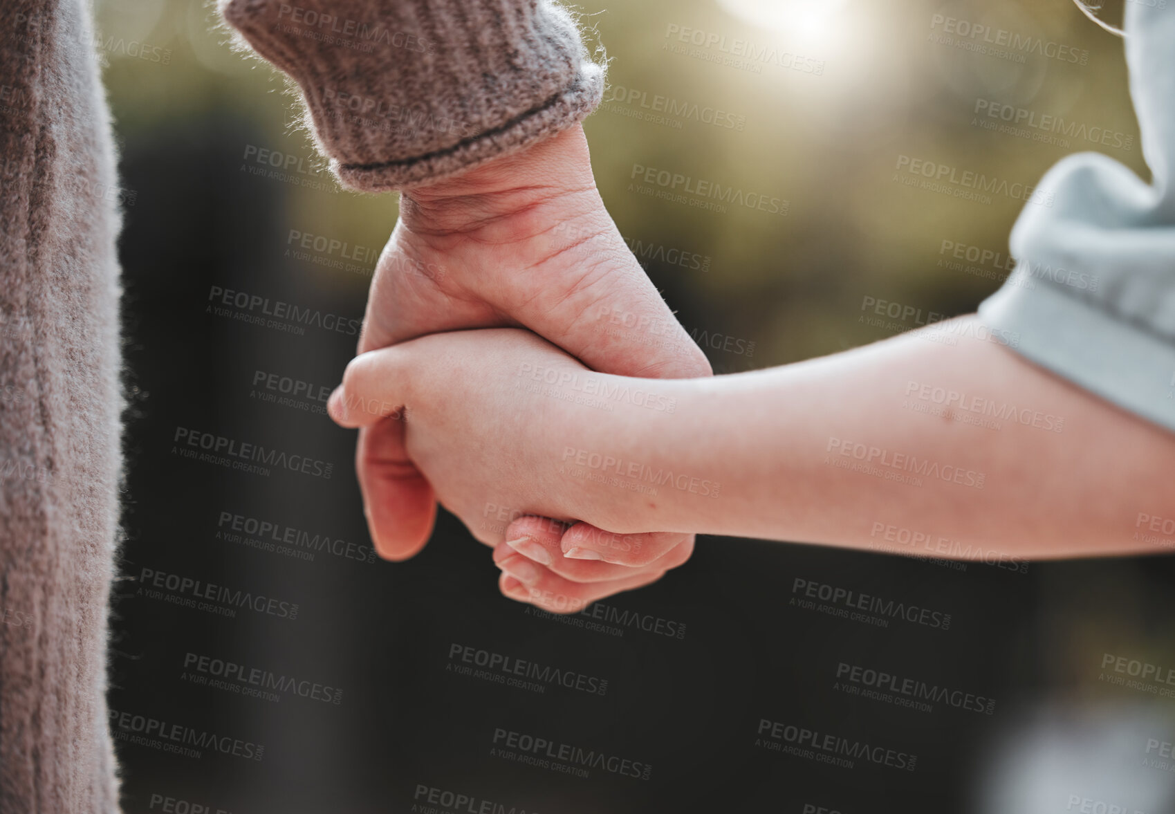 Buy stock photo Walking, park and parents holding hands with child outdoors for adventure, journey and relax outdoors. Family, nature and person with kid for bonding, relationship and support on weekend together