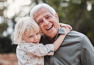 Buy stock photo Shot of an elderly man spending time outdoors with his grandson