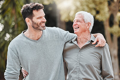 Buy stock photo Shot of a man standing outside with his elderly father