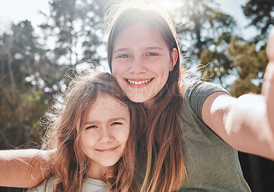 Buy stock photo Shot of a girl taking a selfie with her younger sister