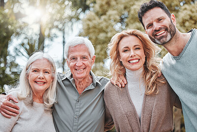 Buy stock photo Shot of a couple standing outside with their elderly parents