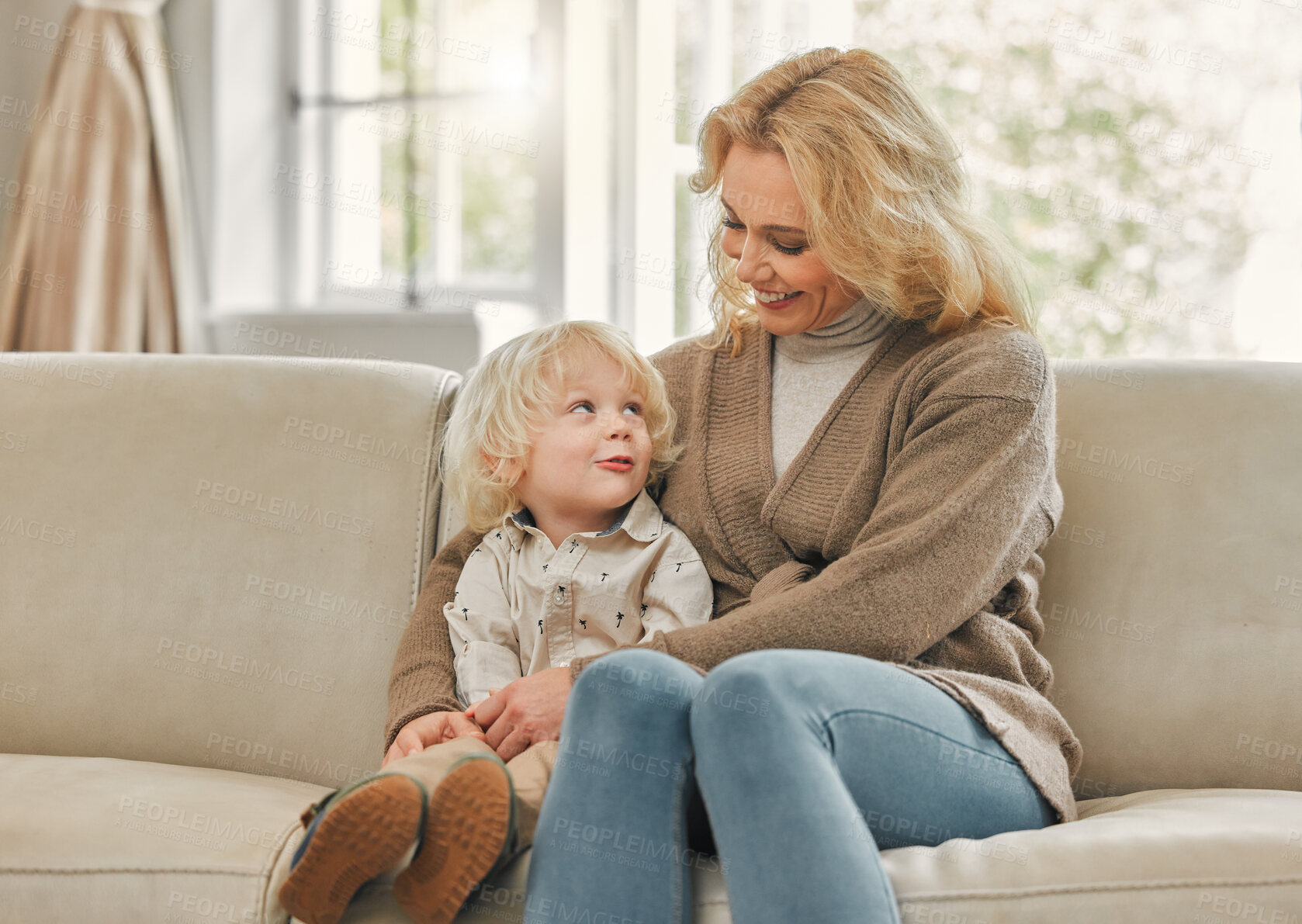 Buy stock photo Shot of a mature mother enjoying time with her son at home