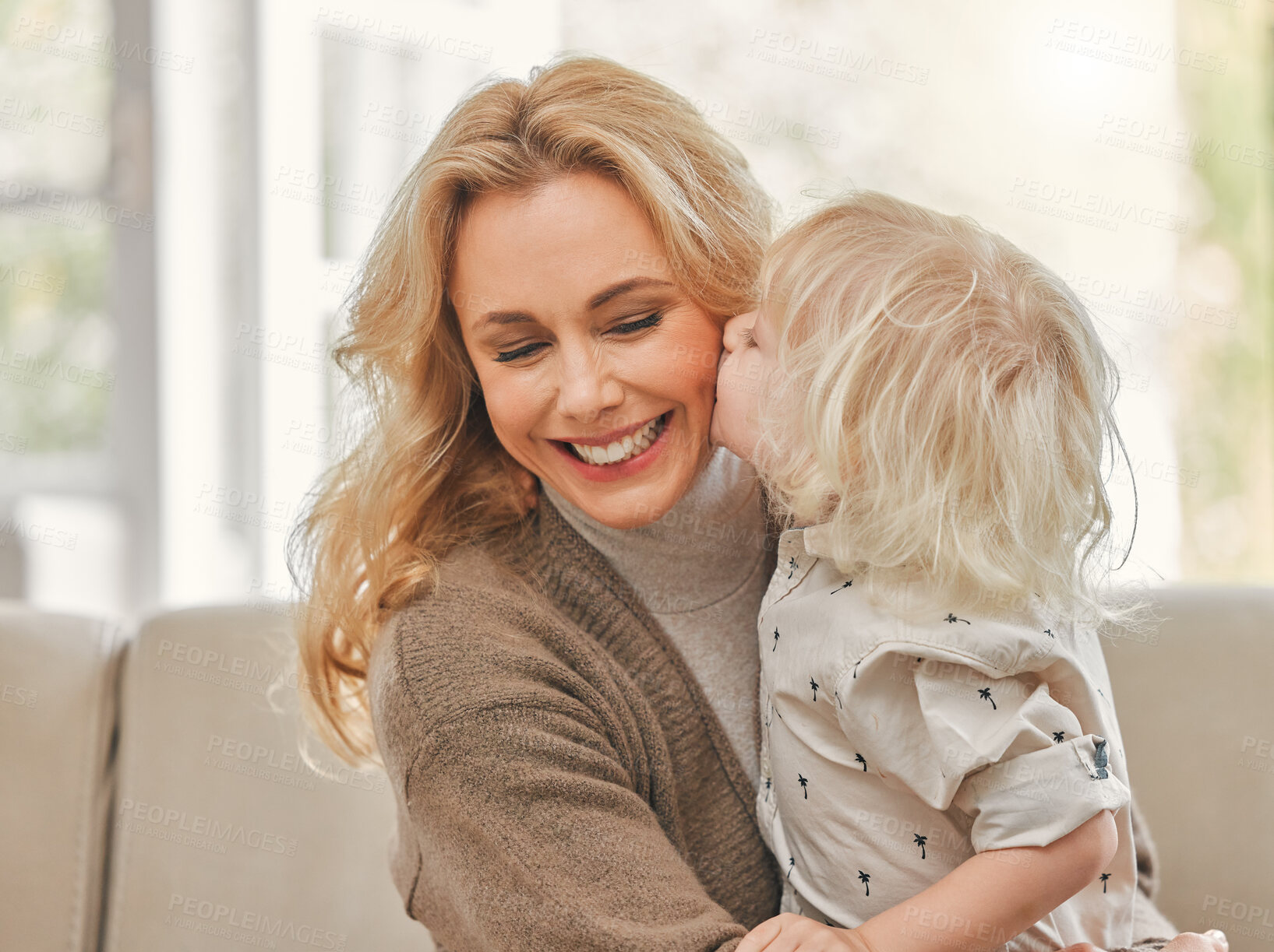 Buy stock photo Shot of a mature mother enjoying time with her son at home