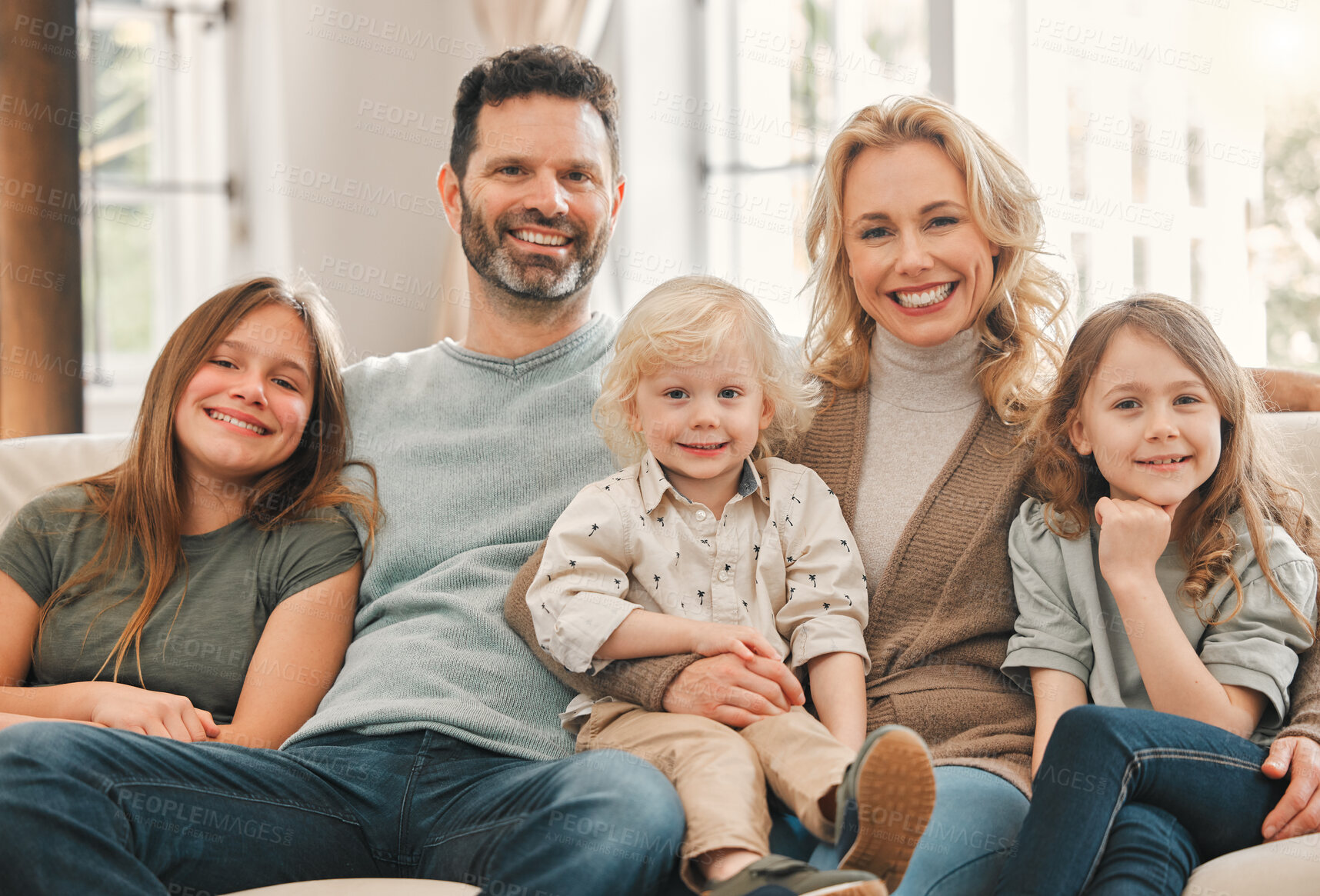 Buy stock photo Portrait, happy family and kids with parents in home to relax, care or bonding together. Face, mother and dad with children in living room for support, love or adoption with foster siblings on sofa