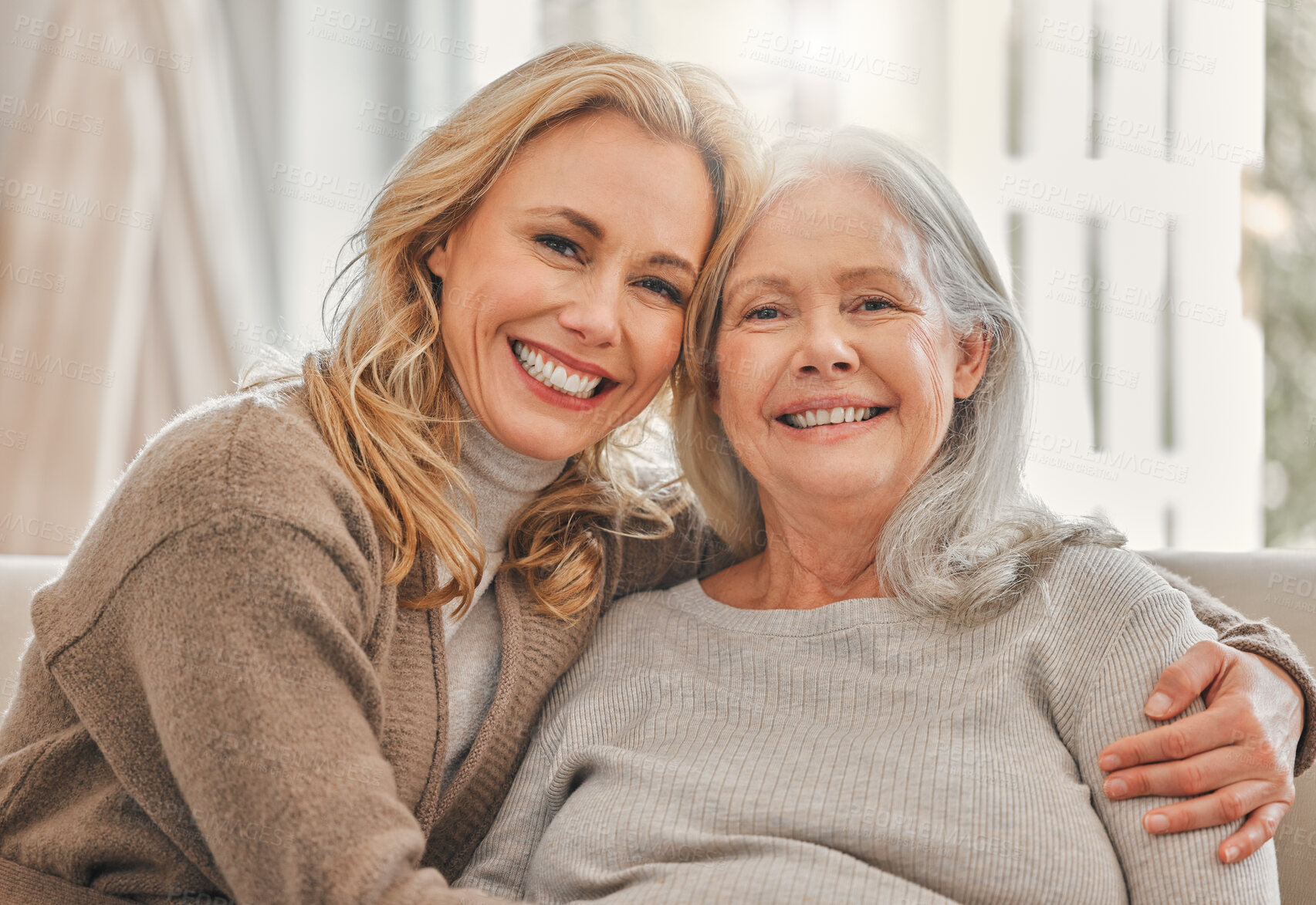 Buy stock photo Hug, portrait or smile with old woman and daughter on sofa in living room of home together for visit. Support, womens day or wellness with person and senior mother embracing in apartment for bonding