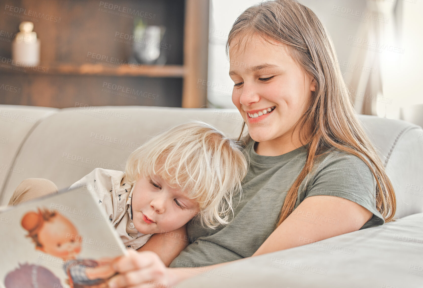 Buy stock photo Girl, child and reading of book on sofa for storytelling, family bonding and learning of language development. Siblings, kids and education for creative fantasy, trust and emotional support at house