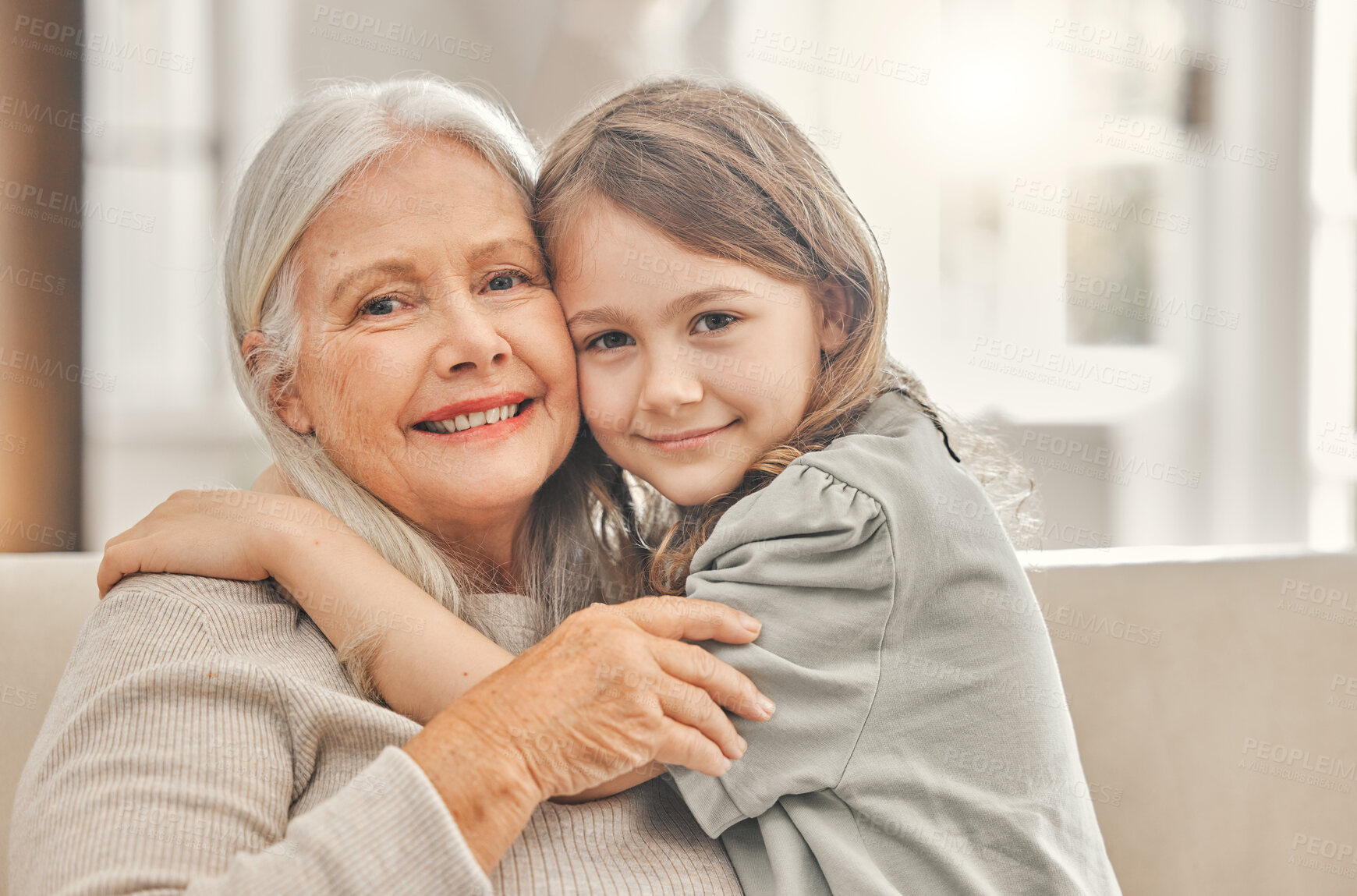 Buy stock photo Grandma, girl and portrait on sofa for hug, love and relationship development at home. Senior woman, grandchild and bonding on couch for family values, womens day and weekend relax in living room