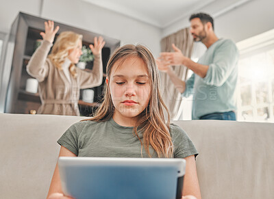 Buy stock photo Shot of a young girl using a digital tablet while her parents argue at home