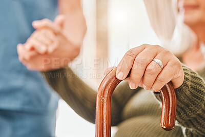 Buy stock photo Shot of an elderly woman using a walking cane with the help of her nurse