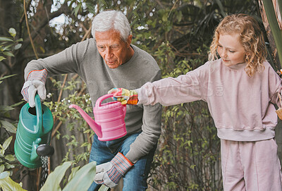 Buy stock photo Shot of an adorable little girl gardening with her grandfather