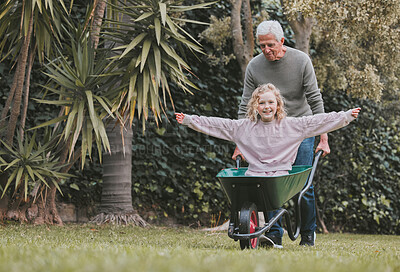Buy stock photo Shot of an adorable little girl having fun with her grandfather in a garden