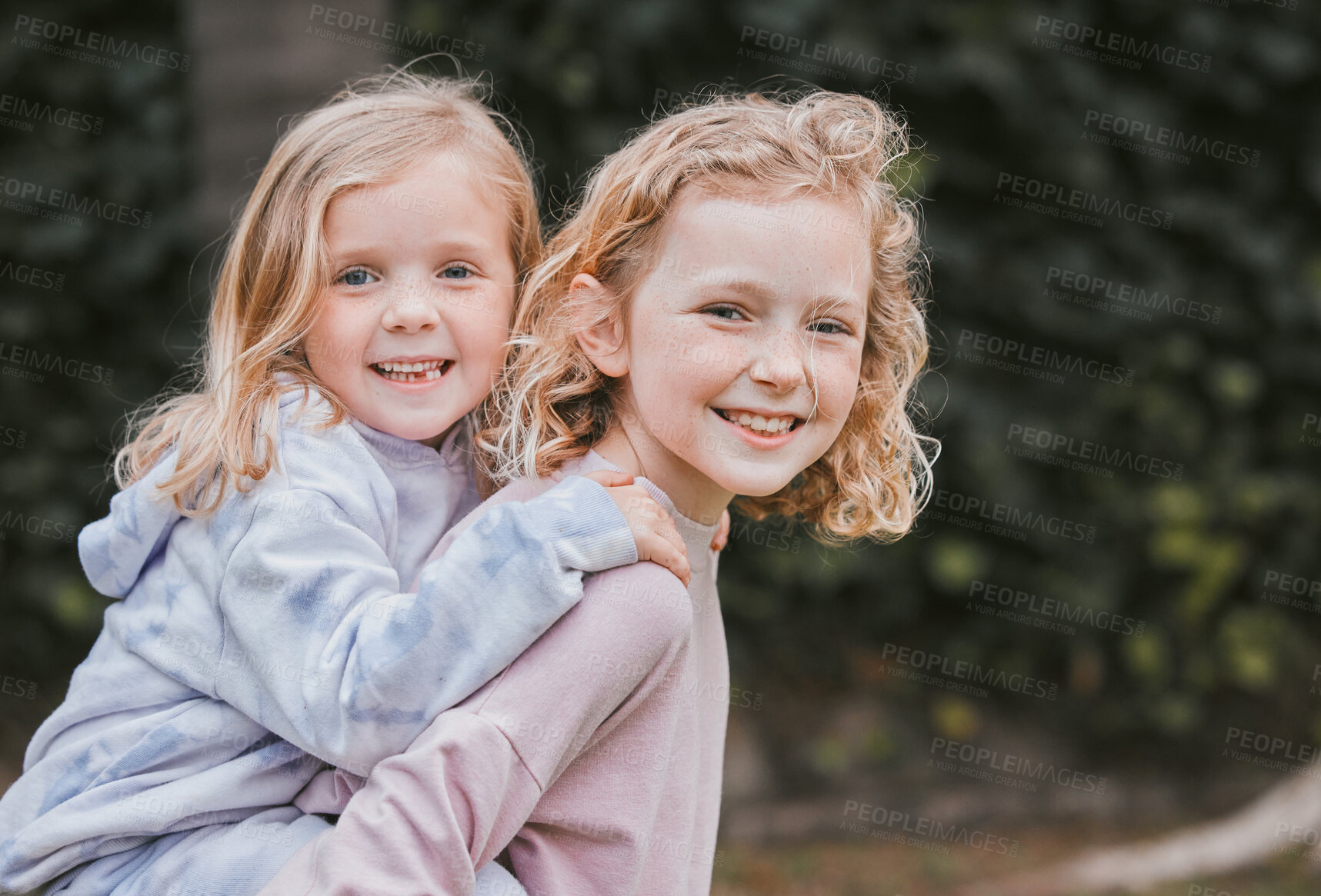 Buy stock photo Shot of two adorable little girls having fun in a garden