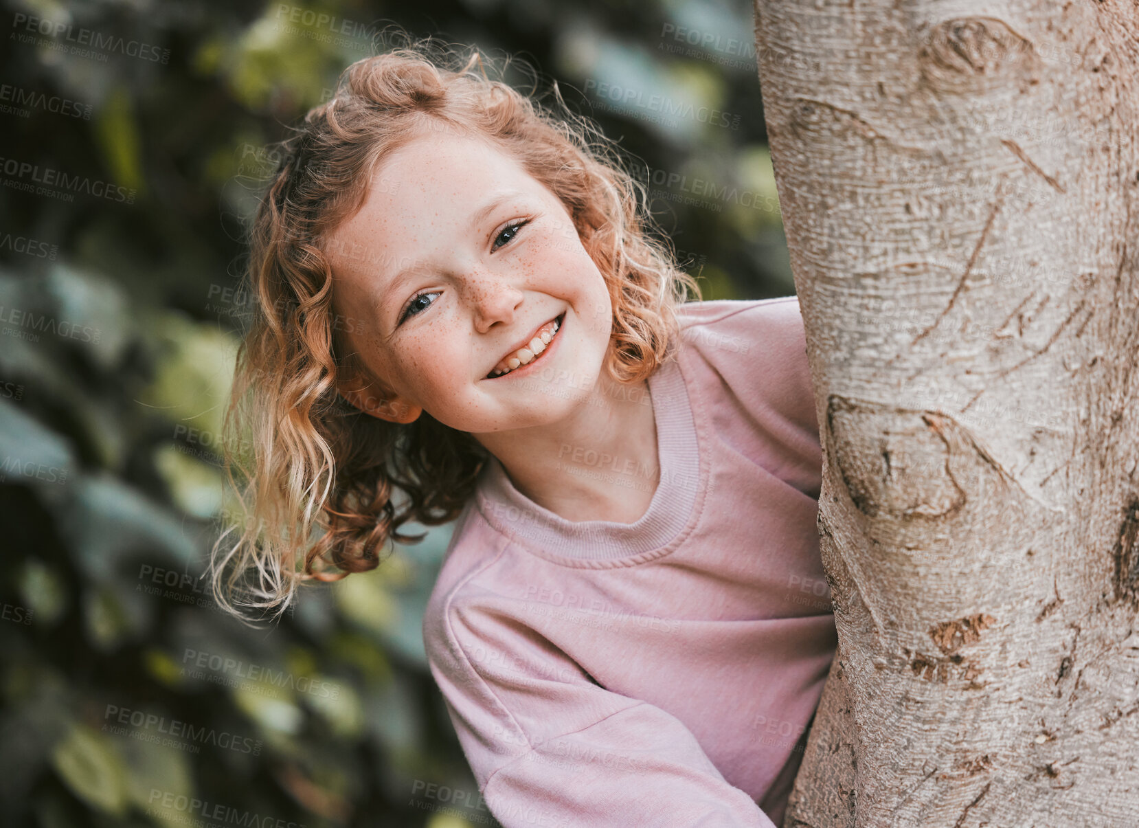Buy stock photo Shot of an adorable little girl hugging a tree in a garden