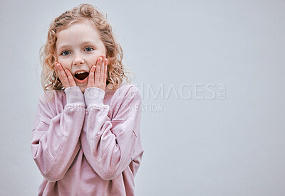 Buy stock photo Studio shot of a little girl looking surprised against a grey background