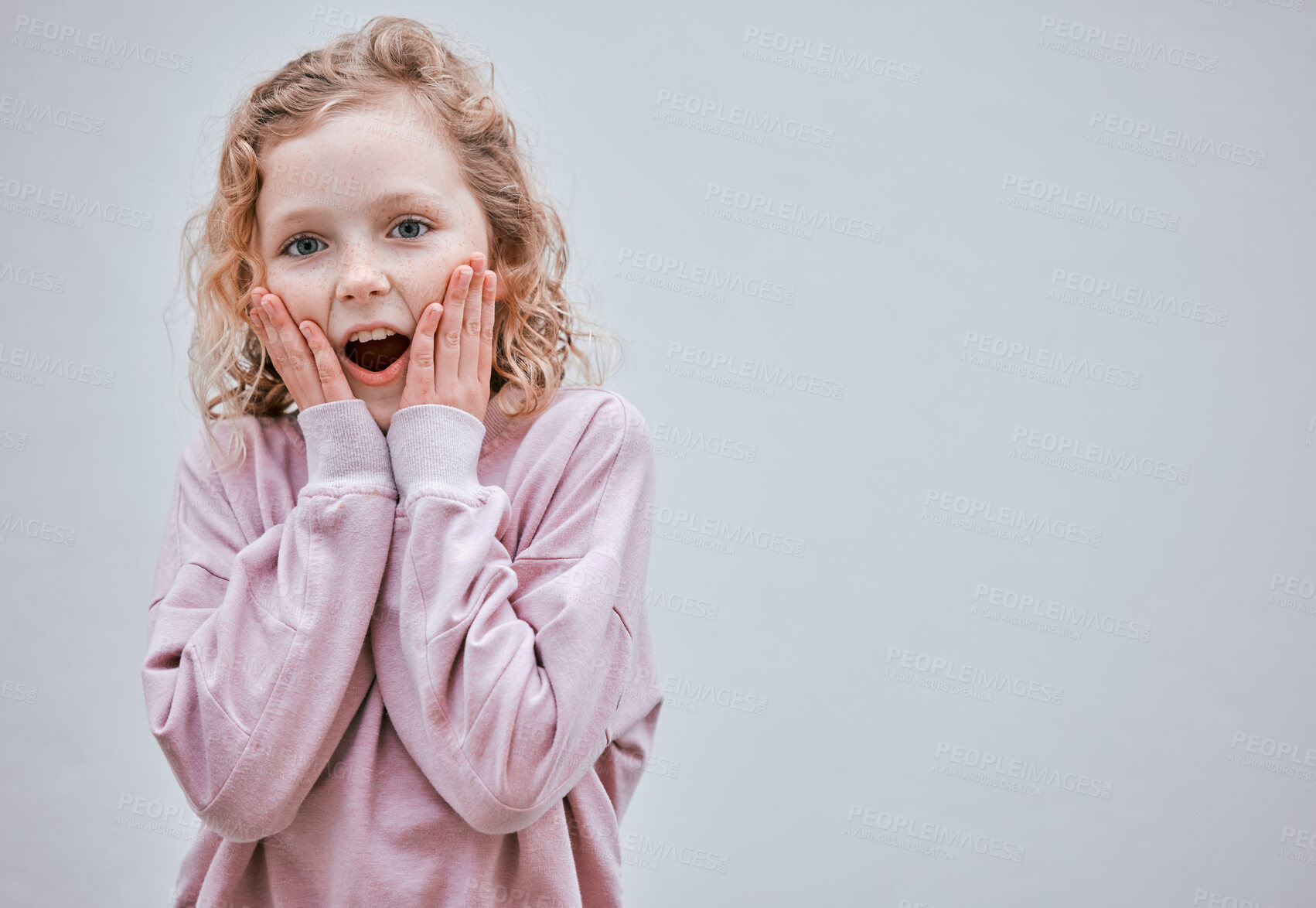 Buy stock photo Studio shot of a little girl looking surprised against a grey background