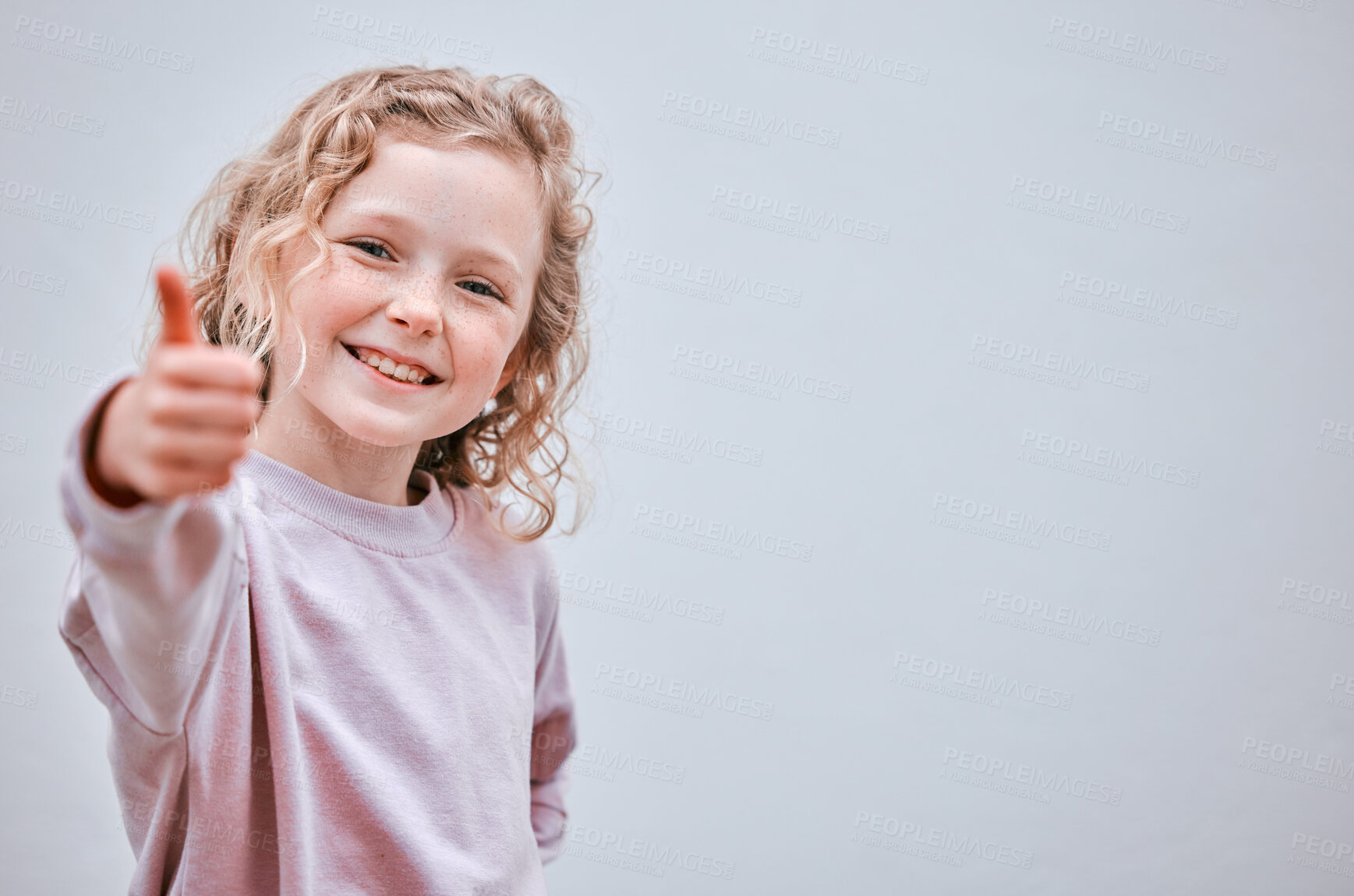 Buy stock photo Girl, child and thumbs up in studio portrait, approval and like emoji or vote on white background. Female person, confident success and thank you for winner motivation, yes and mockup space for sign