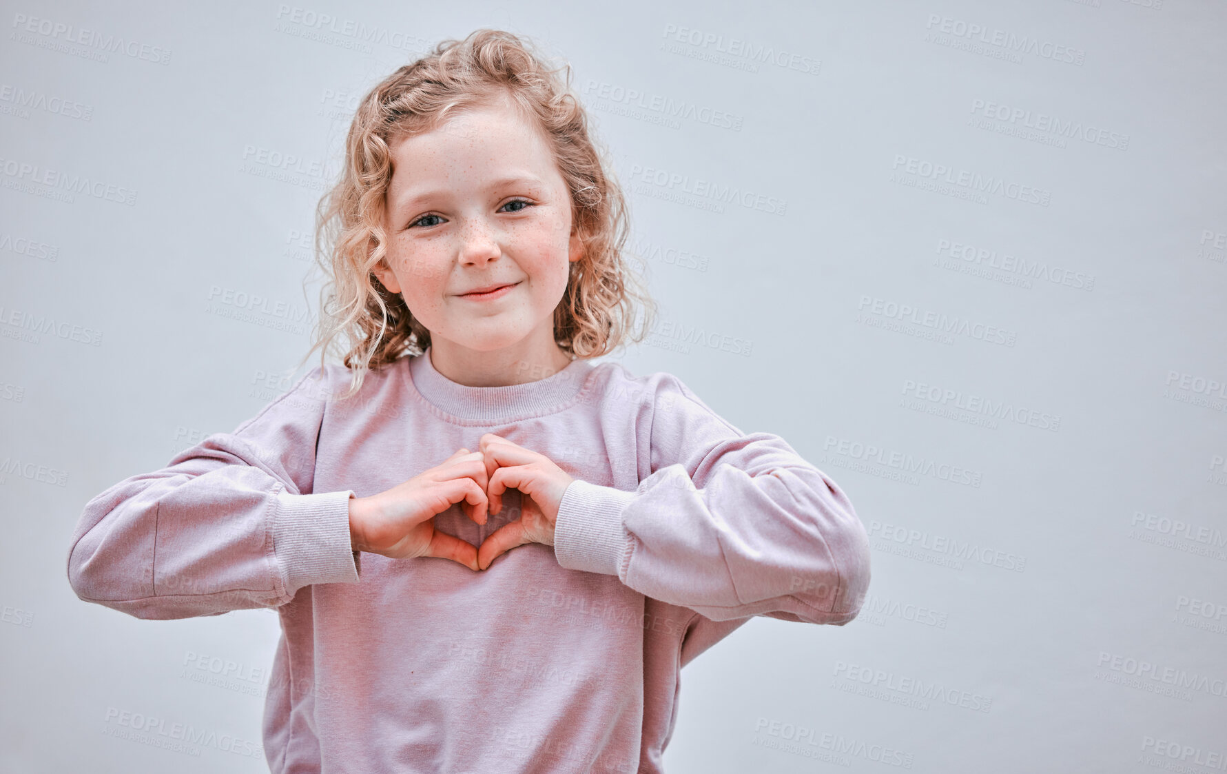 Buy stock photo Girl, portrait and child for heart shape in studio, love emoji and sign of support on white background. Female person, kid and symbol of kindness or peace, mockup space and thank you or happy review