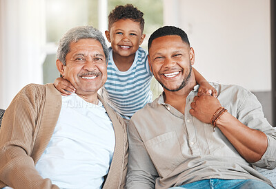 Buy stock photo Portrait of a mature man sitting with his son and holding his grandson at home