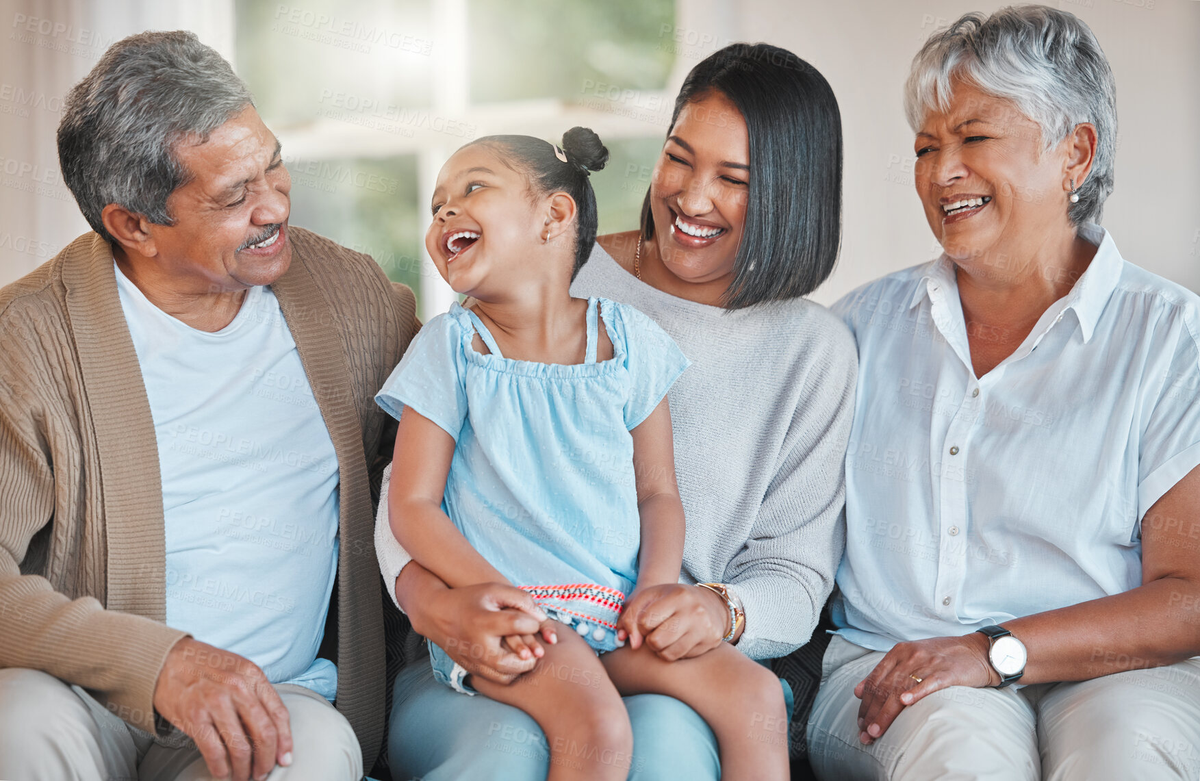 Buy stock photo Shot of a mature couple bonding with their daughter and grandchild at home