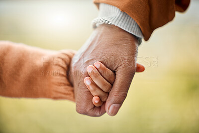 Buy stock photo Shot of a little girl holding her father's hand outside