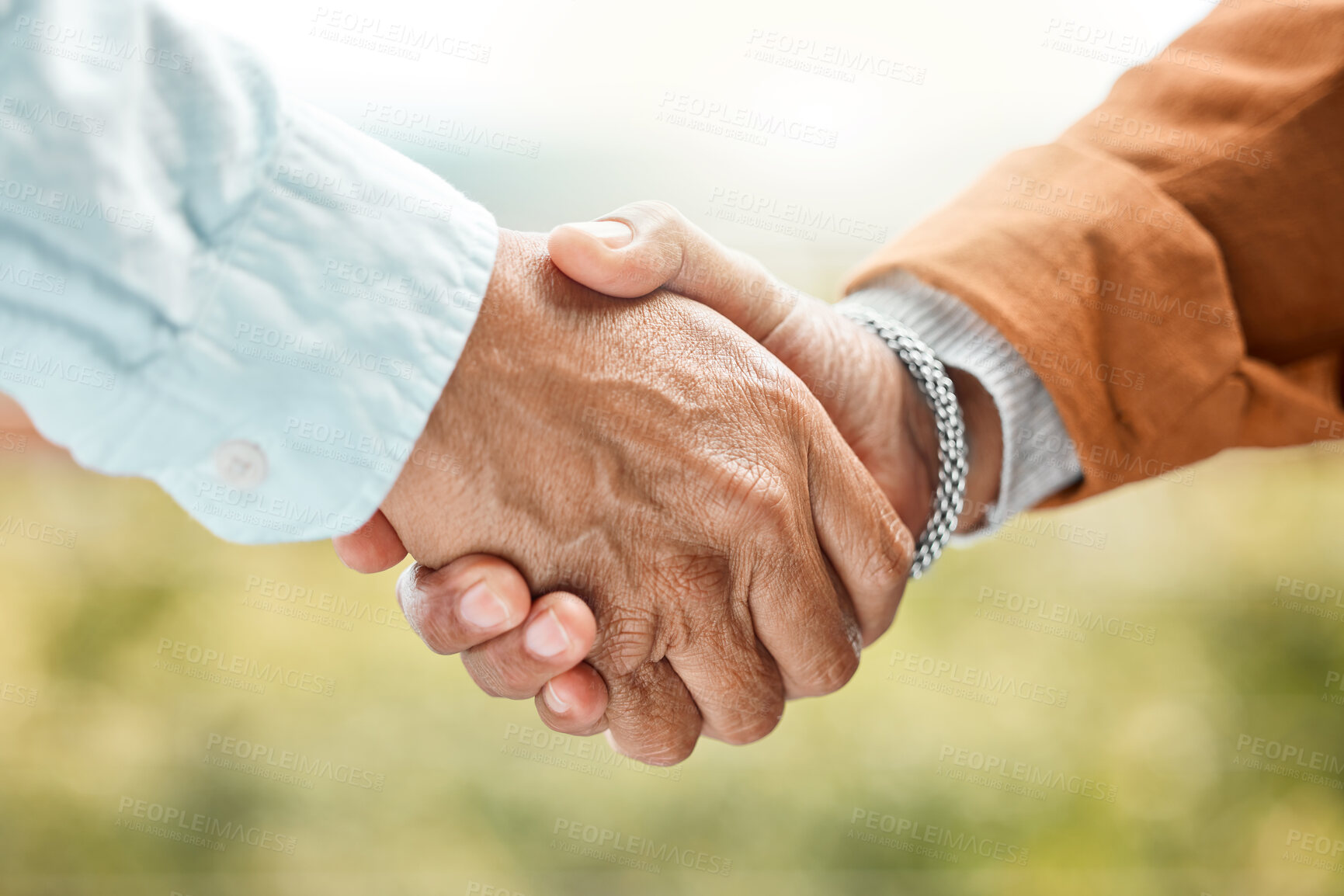 Buy stock photo Shot of two unrecognizable men shaking hands outside