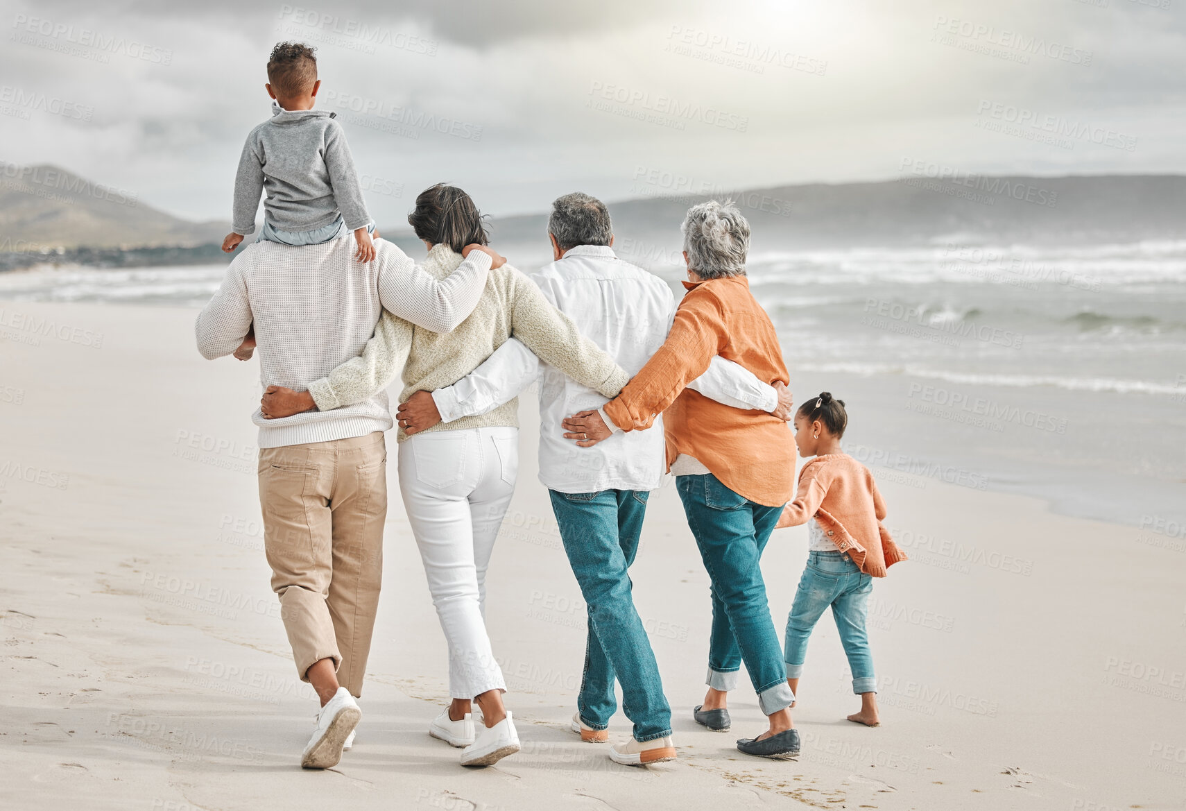 Buy stock photo Happy, family and beach back with grandparents, mom and dad with kids together on holiday. Walking, winter and retirement with vacation and school break by the sea with love, parent care and bonding