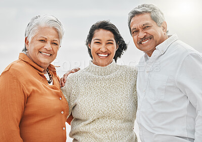 Buy stock photo Cropped shot of an attractive young woman and her parents on the beach