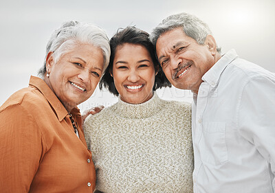 Buy stock photo Cropped shot of an attractive young woman and her parents on the beach